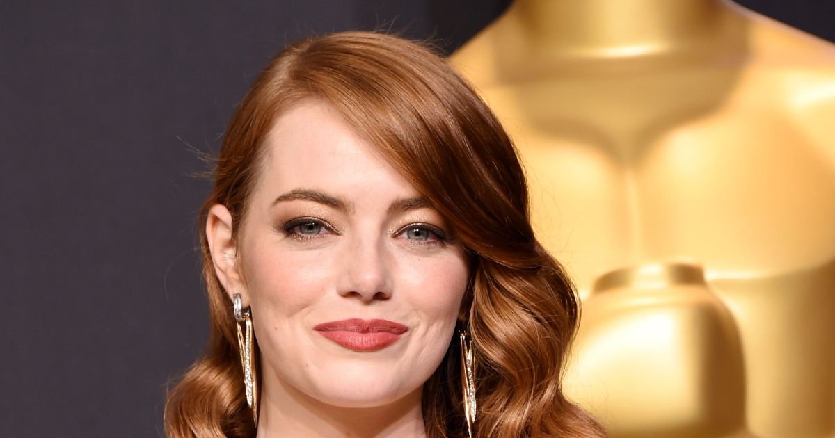 Emma Stone cradles baby bump as pregnancy is revealed