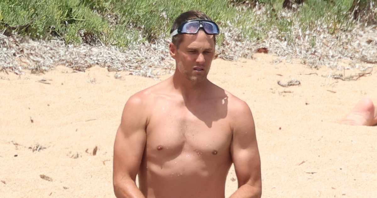 Tom Brady shows off his buff bod in short white swim trunks, plus
